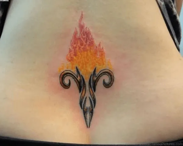 flaming aries symbol tattoo on the lower back