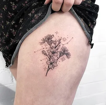 Floral Virgo constellation tattoo on the thigh