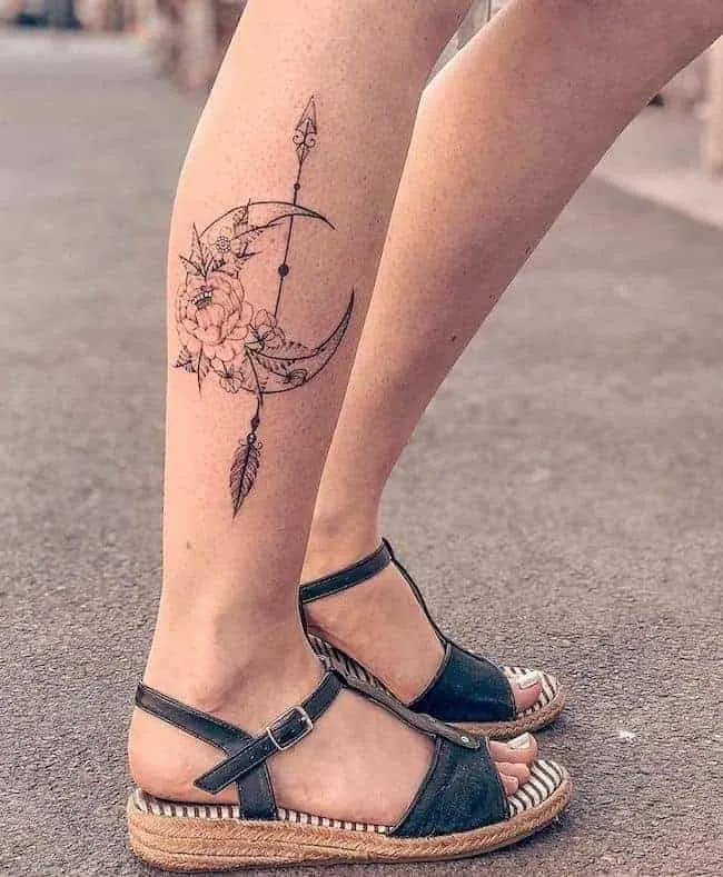 floral moon with arrow tattoo on the leg