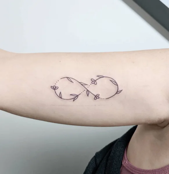delicate line art flower infinity tattoo