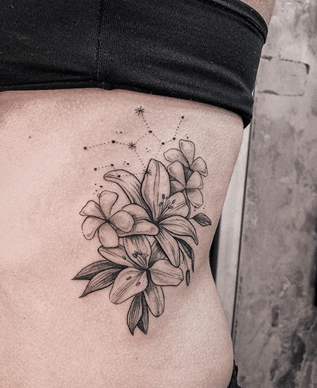 flowers and Virgo constellation tattoo on the body