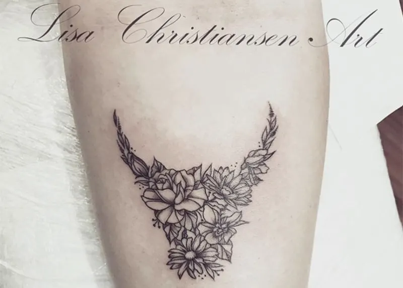 flowery bull tattoo on the arm