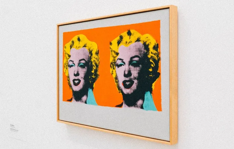 framed portrait of marilyn monroe placed on a white wall