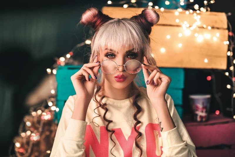 girl with two hair buns wearing glasses