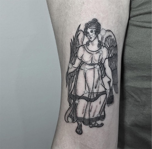 goddess Astraea tattoo on the arm