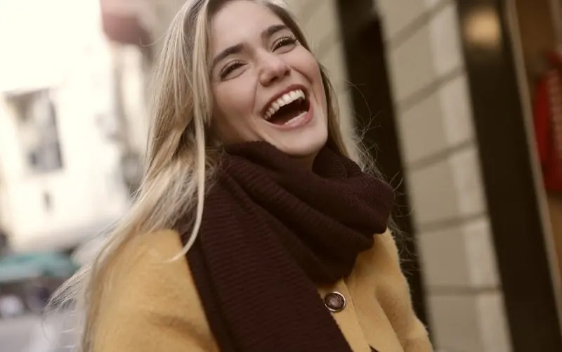 Happy laughing woman outdoors during daytime