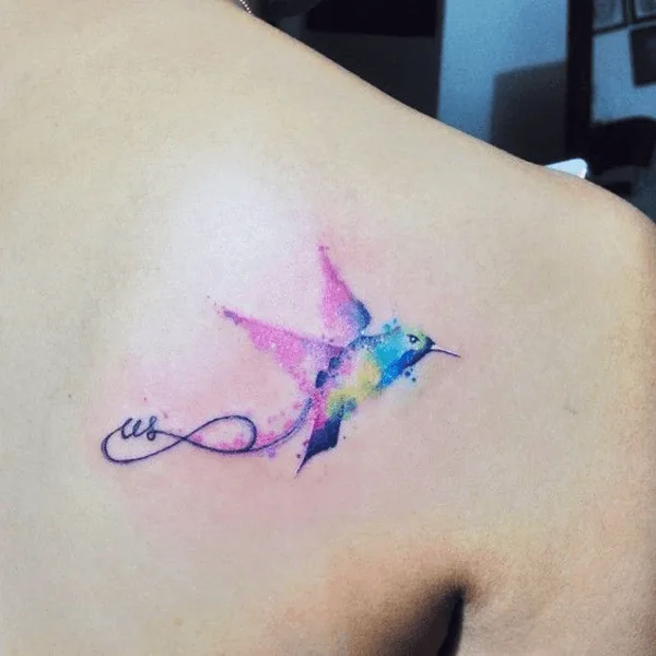 brightly-colored humming-bird tattoo on back