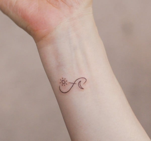 infinity design with sun and moon tattoo on wrist