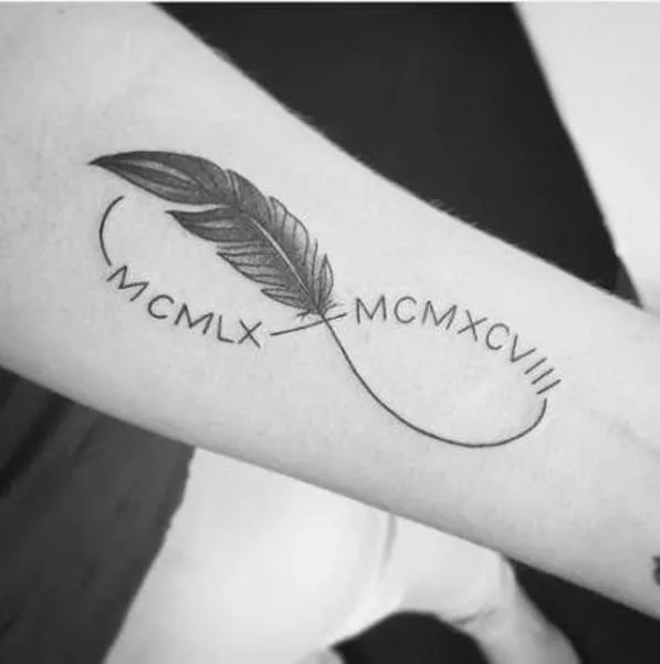 feather and roman numeral date tattoo