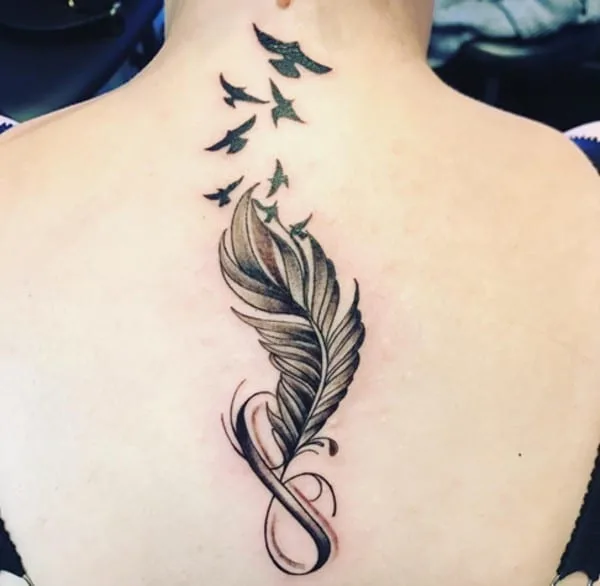 infinity tattoo with feather and birds on back