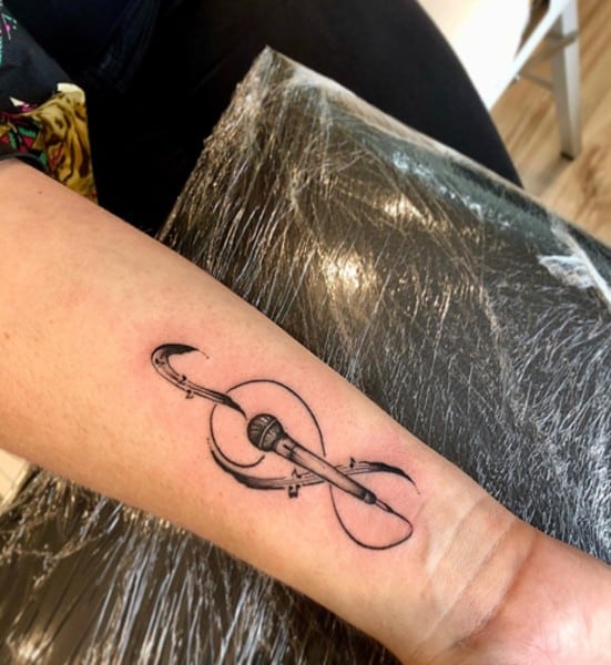 infinity sign with microphone on wrist