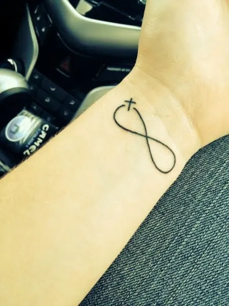 infinity with cross tattoo on wrist