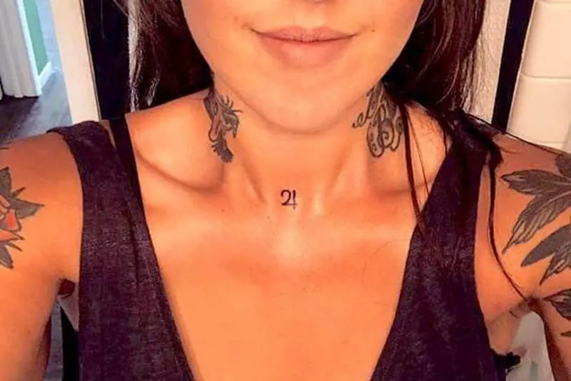 jupiter symbol tattoo on the neck