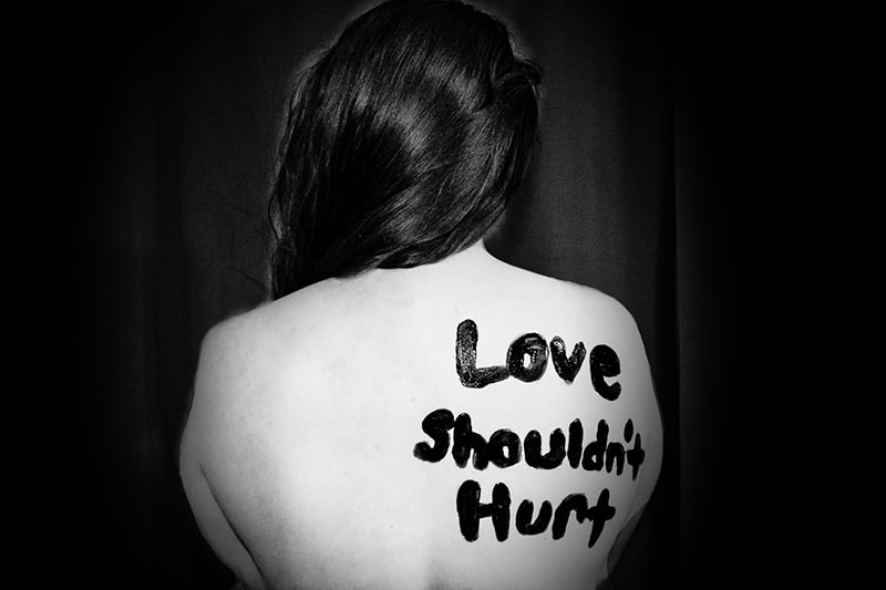 love shouldn`t hurt printed on the back