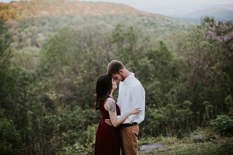 man and woman about to kiss in the forest during daytime