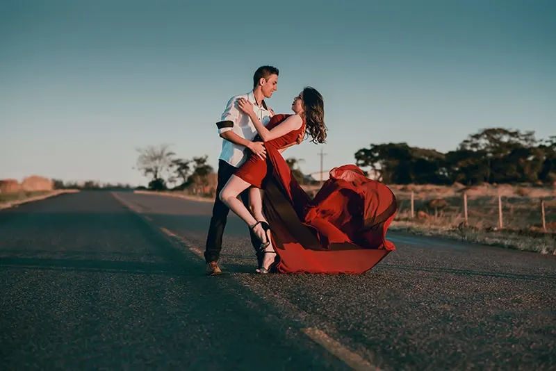 man and woman dancing on the road