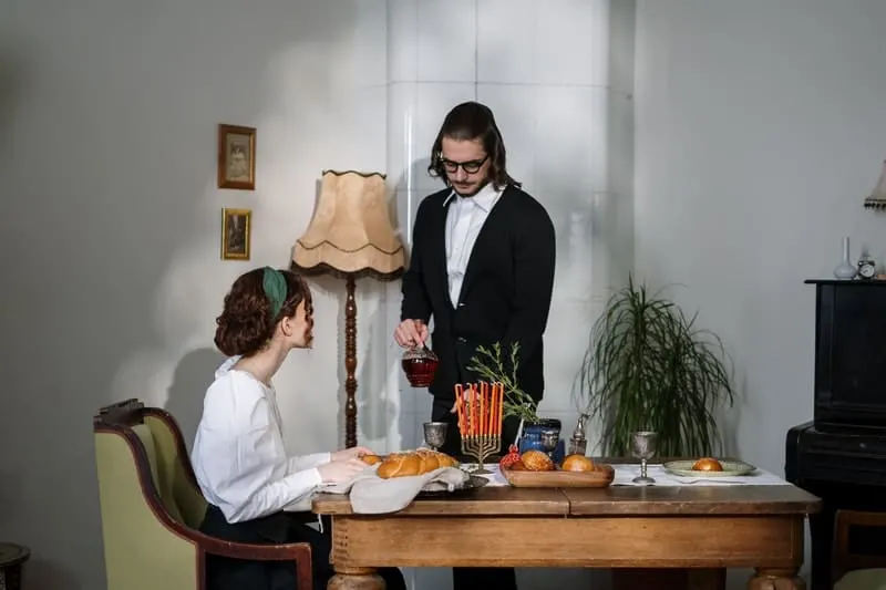 man and woman dating in a traditional jewish dinner