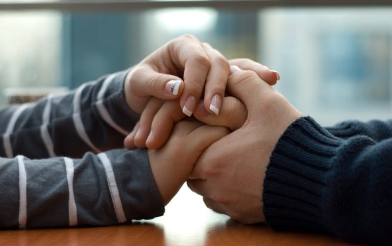 Holding hands of man and woman