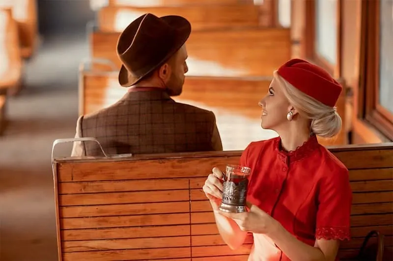 man and woman sitting opposite each other in vintage formal wears