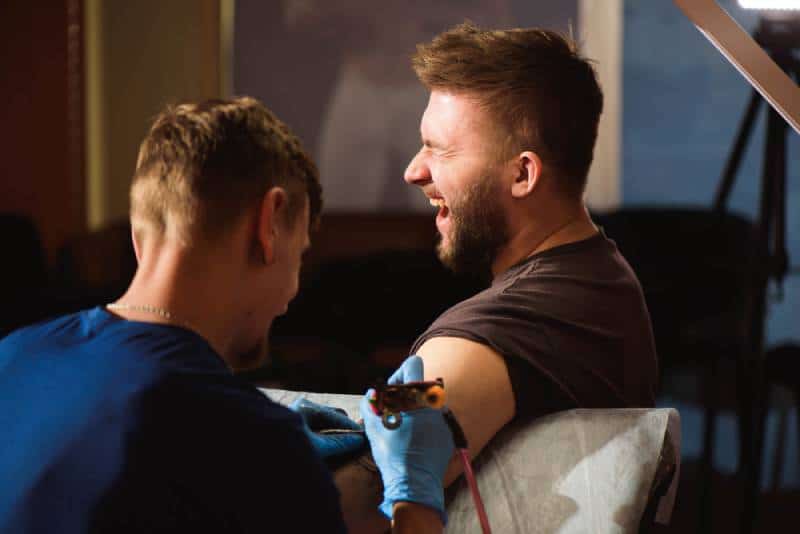man getting tattoo