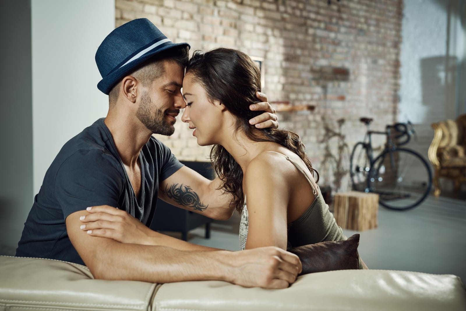 man in love hugging woman on the couch