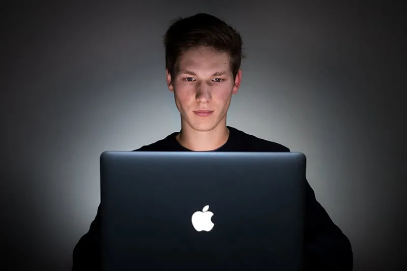 man wearing black shirt using computer
