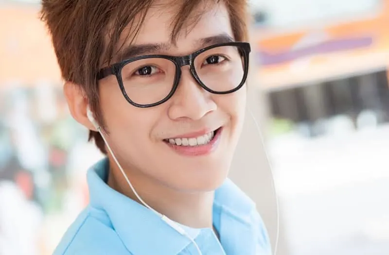 man with earphones with eyeglass smiling