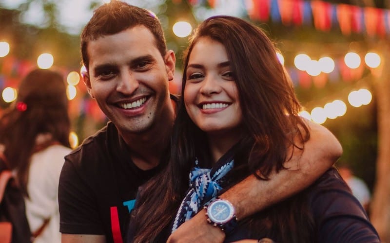 Man with hand around woman head