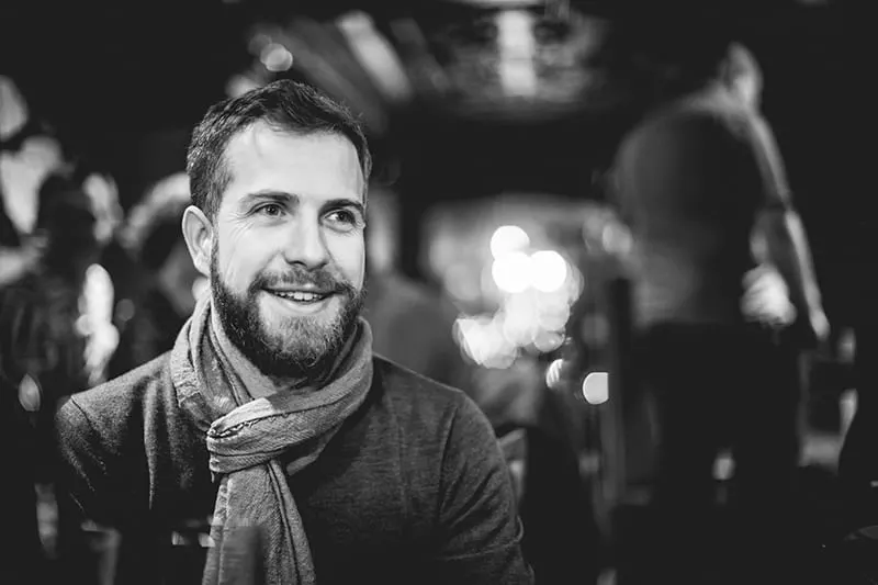 man with scarf smiling