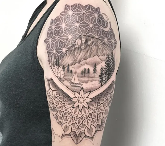 mandala inspired style tattoo with mountain and lake scenery under a constellation