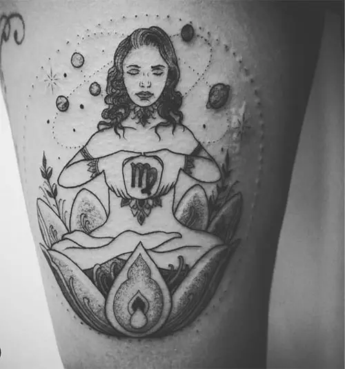 meditating woman inside of a lotus tattoo surrounded with planets