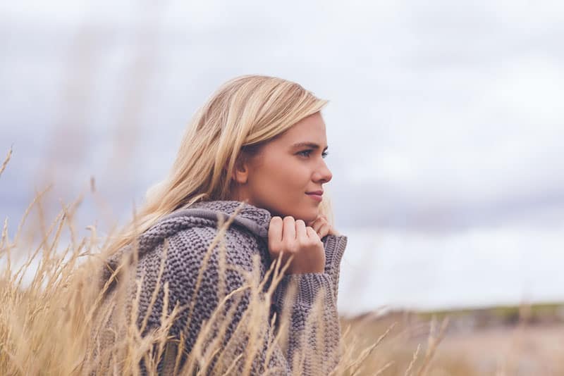 mindful woman sitting in field