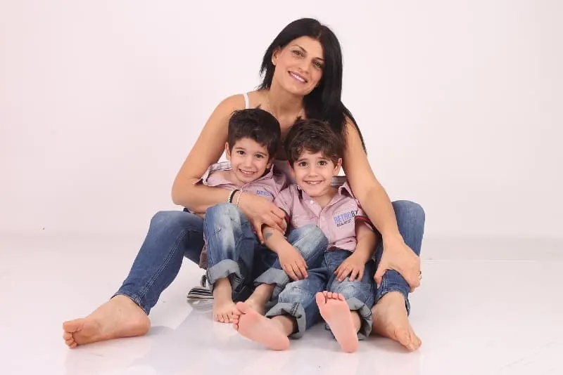 mother sitting on floor with male twins
