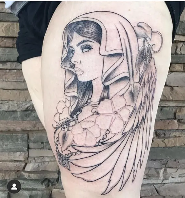 mystic woman with wings tattoo on the thigh