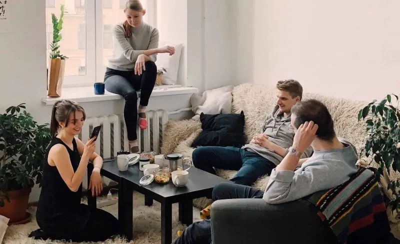 People gathered inside house sitting on sofa during daytime