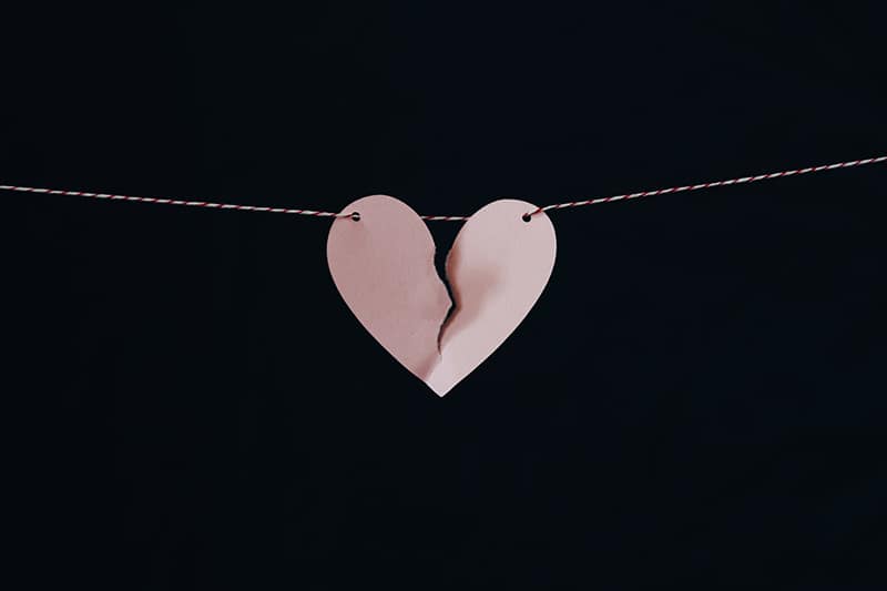 pink broken paper heart hanging on wire