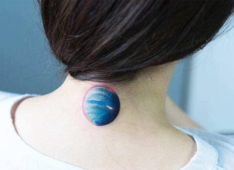 planet neptune tattoo on woman`s neck