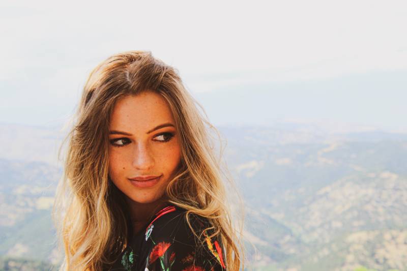 portrait of woman standing on hill