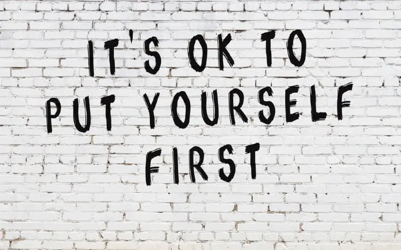 It's ok to put yourself first written on bricks wall