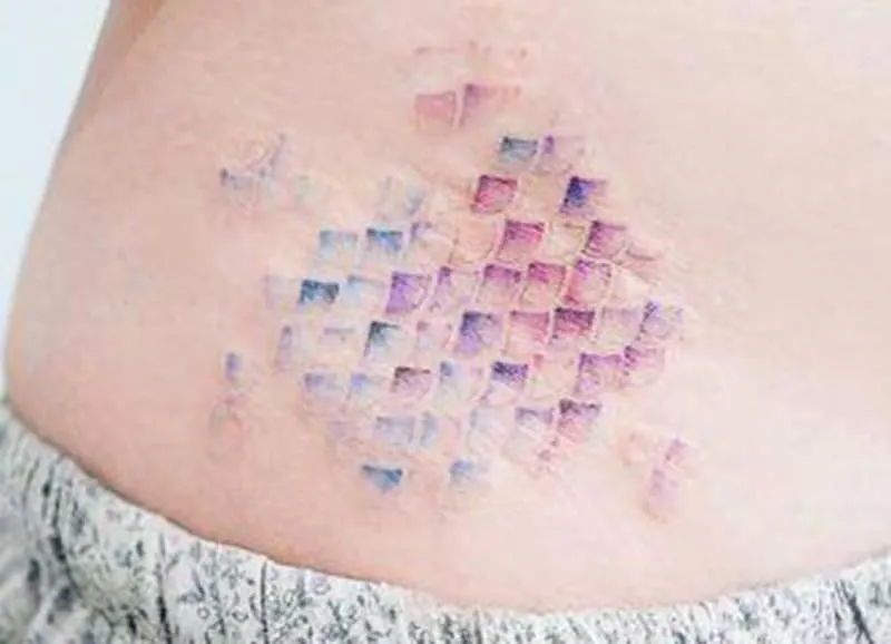rainbow scales pisces tattoo on the stomach