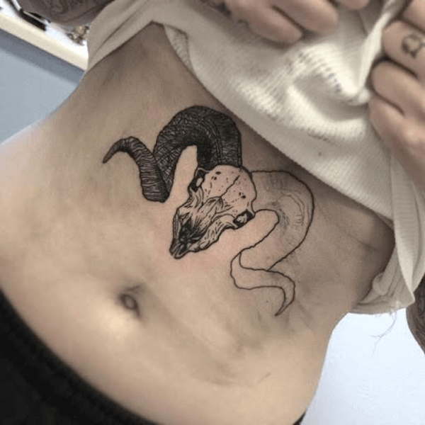 ram skull tattoo under chests