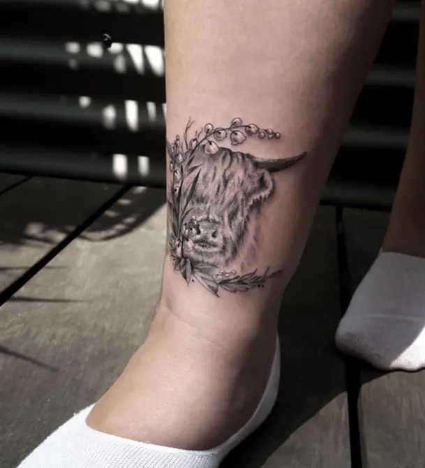 realistic taurus tattoo on the leg