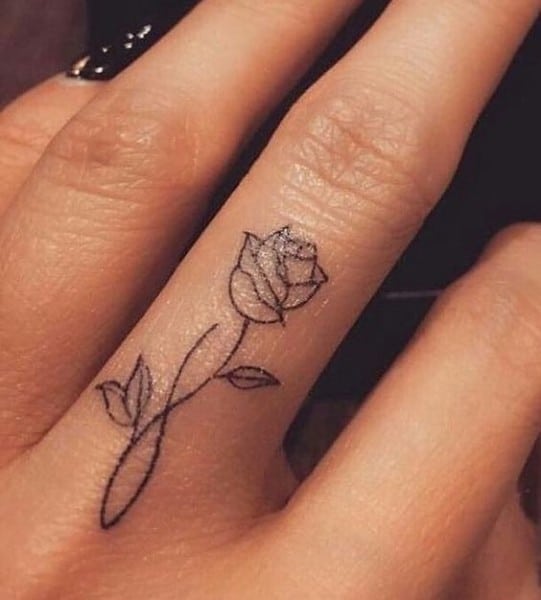 simple rose tattoo on finger