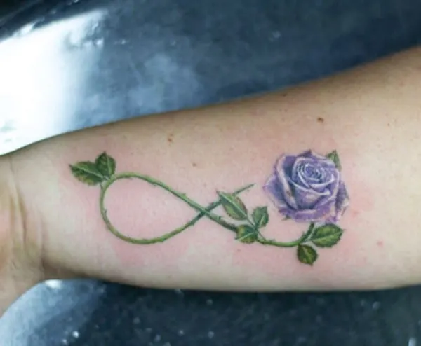 blue realistic rose with green stem infinity tattoo