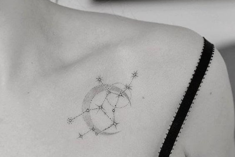 sagittarius constellation and moon symbol tattoo on woman`s chests