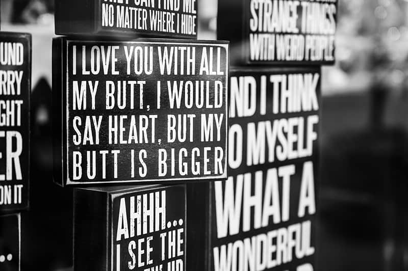 signages with love quotes in black and white