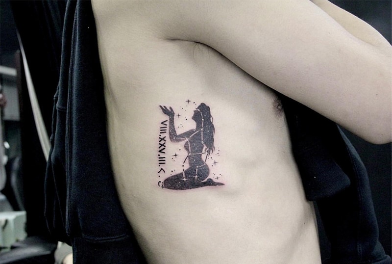 silhouette of a woman tattoo with Roman numerals