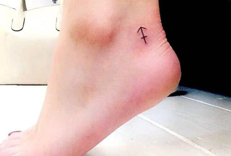 simple and small sagittarius tattoo on the ankle