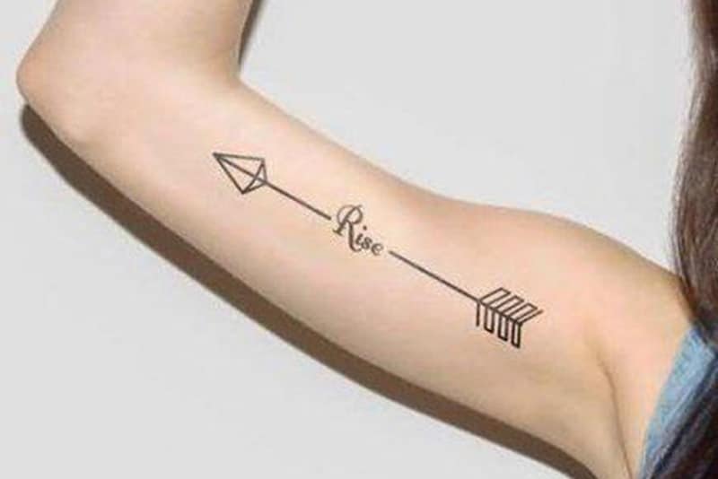 simple arrow tattoo on the arm