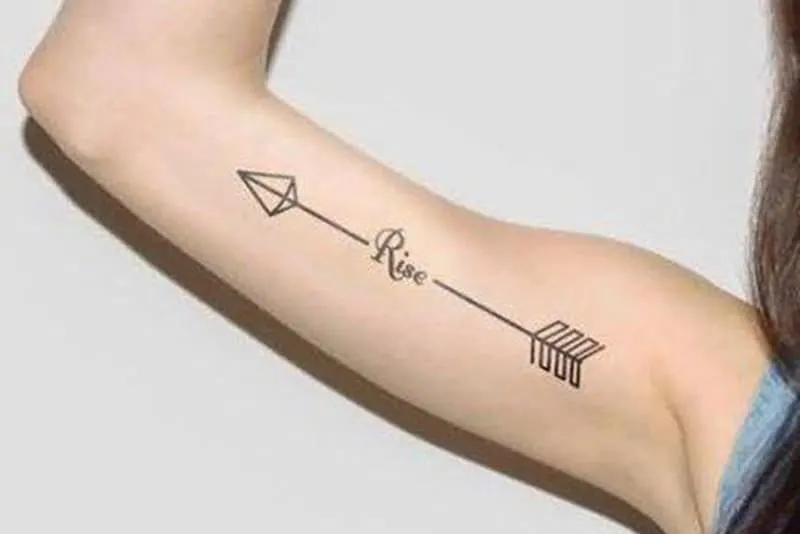 simple arrow tattoo on the arm